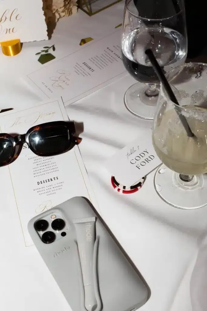 Table setting with a phone and sunglasses