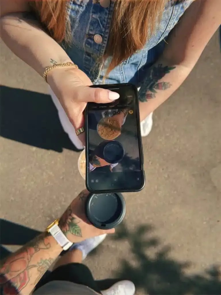 Hands holding a phone outdoors