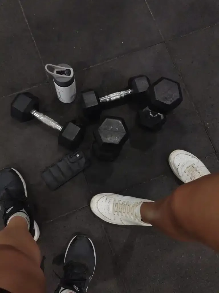 Dumbbells and trainers on a gym floor