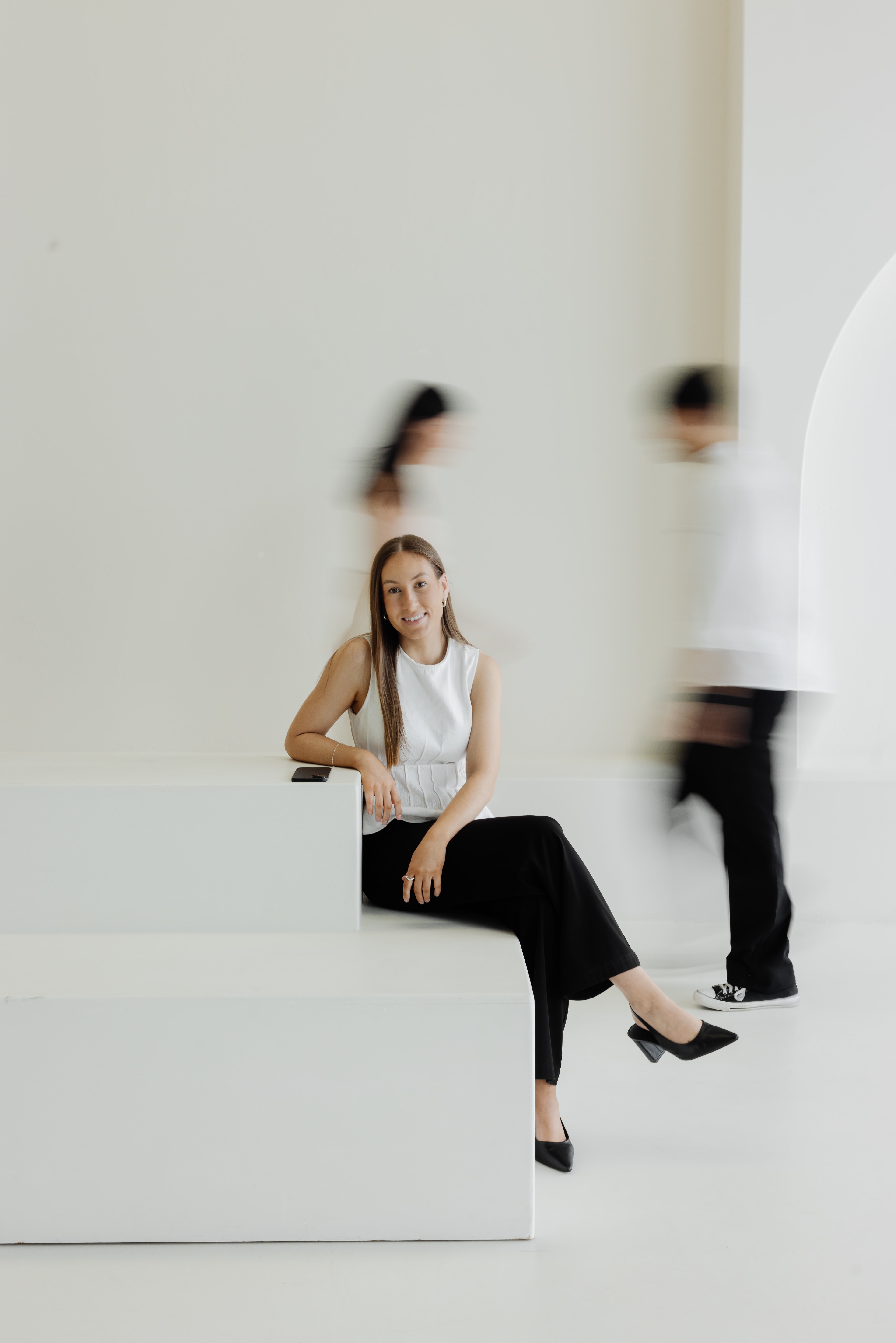 Brink team member sitting with two blurry people in background